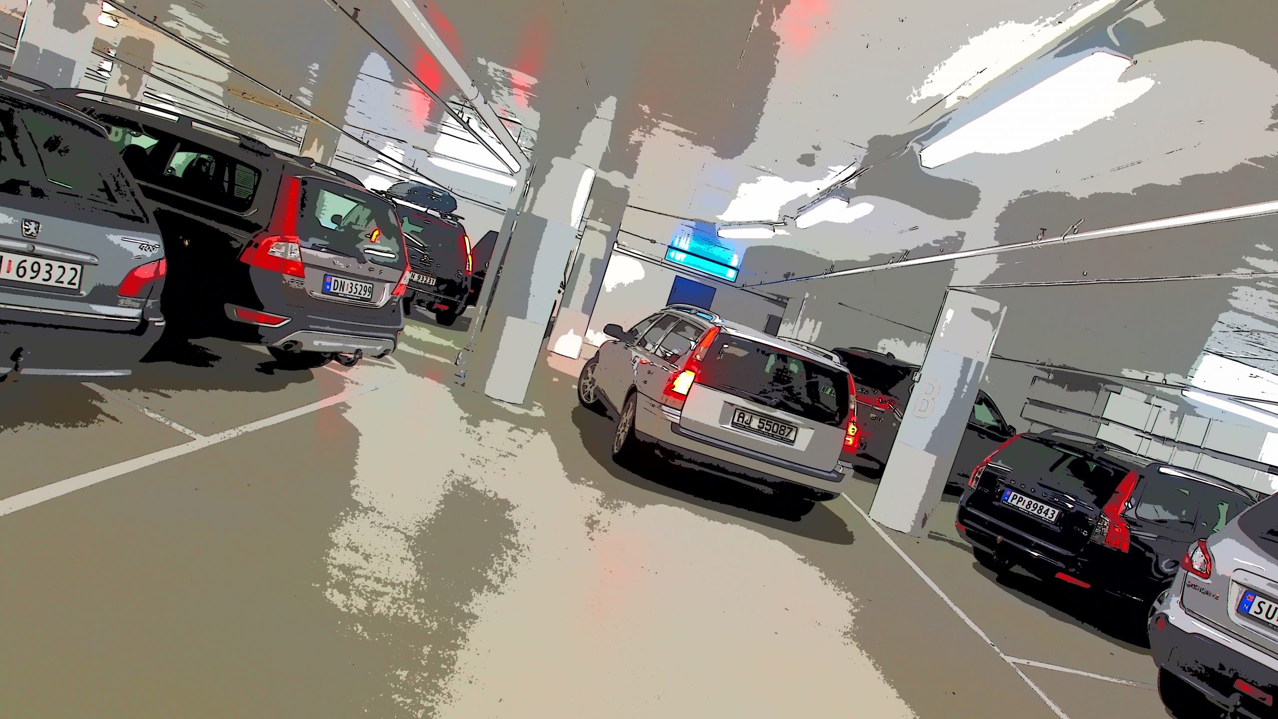 Kilka samochodów na parkingu podziemnym, zdjęcie obrócone pod kątem 45 stopni